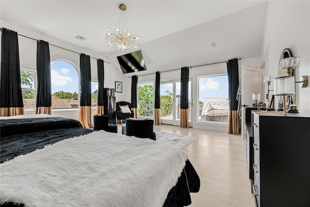 3 Fairview Ln, Glen Cove, NY 11542 - bedroom with access to exterior, lofted ceiling, multiple windows, light wood finished floors, and a chandelier