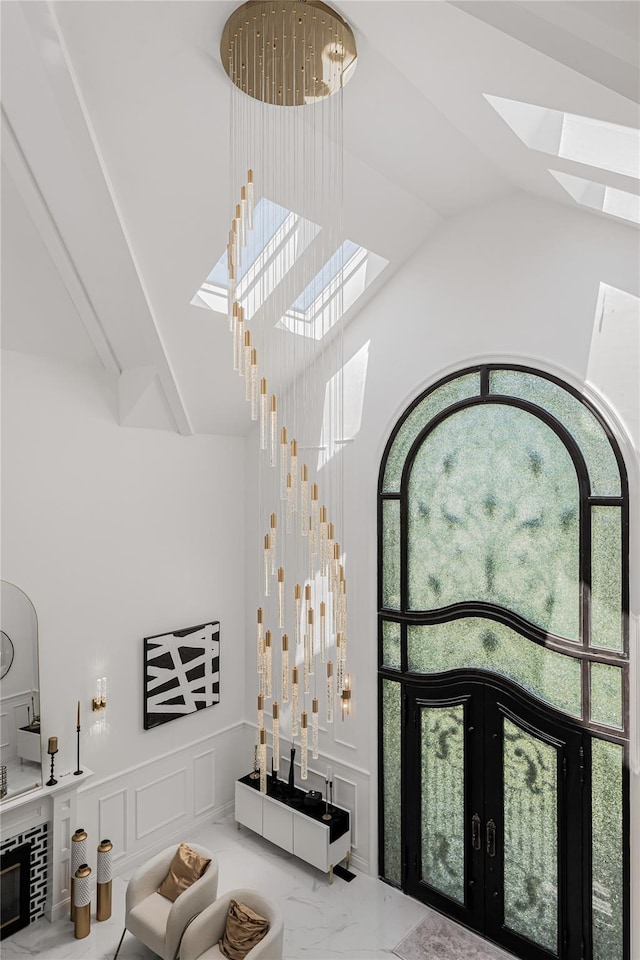 3 Fairview Ln, Glen Cove, NY 11542 - interior space featuring a skylight, lofted ceiling, marble finish floors, and french doors