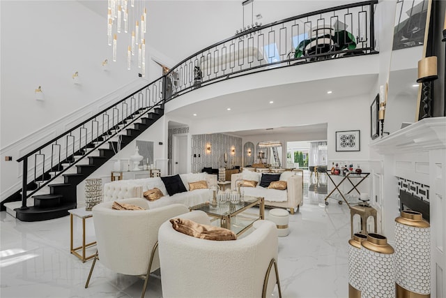 3 Fairview Ln, Glen Cove, NY 11542 - living room featuring marble tiled flooring, stairs, a high ceiling, and a chandelier