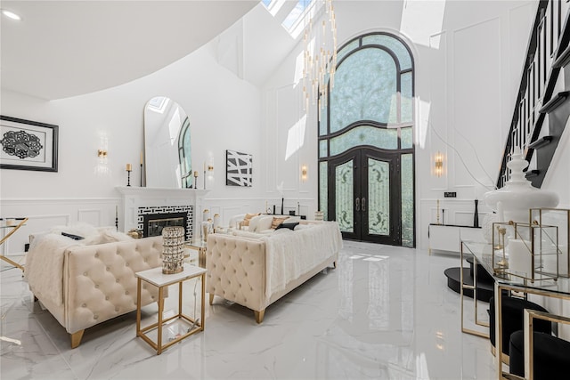 3 Fairview Ln, Glen Cove, NY 11542 - living area with a decorative wall, light marble finish floors, a high ceiling, french doors, and a wainscoted wall