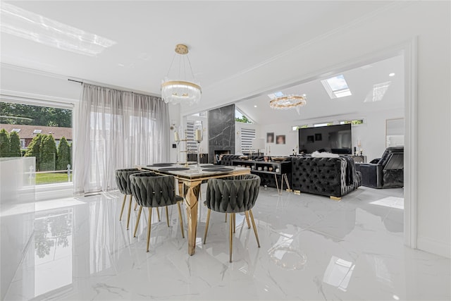 3 Fairview Ln, Glen Cove, NY 11542 - dining area featuring a chandelier, light marble finish flooring, a premium fireplace, and crown molding