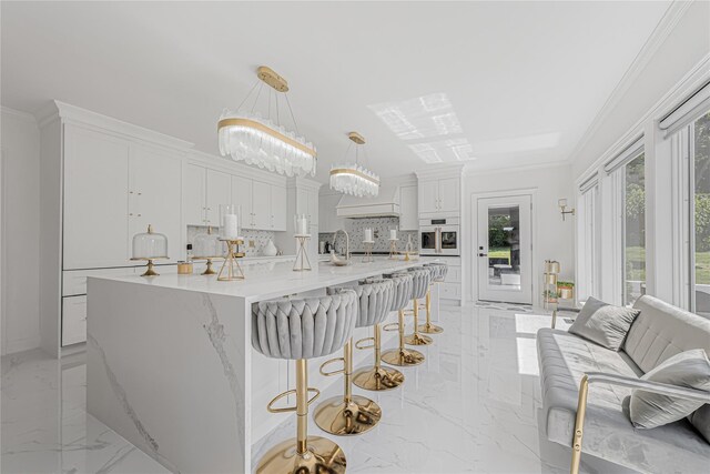 3 Fairview Ln, Glen Cove, NY 11542 - kitchen with light marble finish flooring, white oven, decorative backsplash, white cabinetry, and crown molding