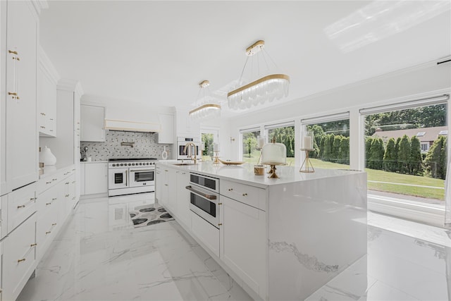 3 Fairview Ln, Glen Cove, NY 11542 - kitchen featuring white appliances, healthy amount of natural light, white cabinetry, and light marble finish floors