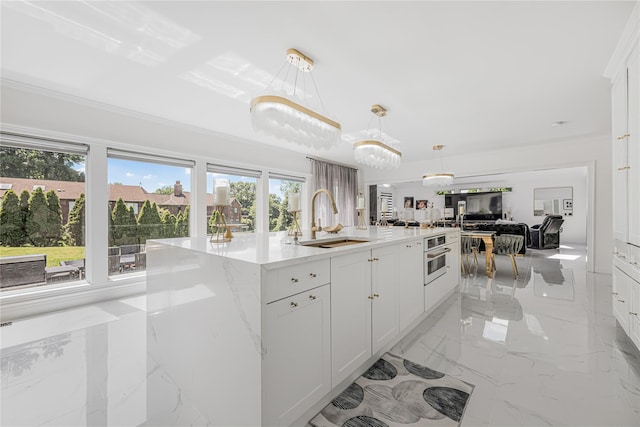 3 Fairview Ln, Glen Cove, NY 11542 - kitchen with healthy amount of natural light, open floor plan, a kitchen island with sink, and white cabinetry