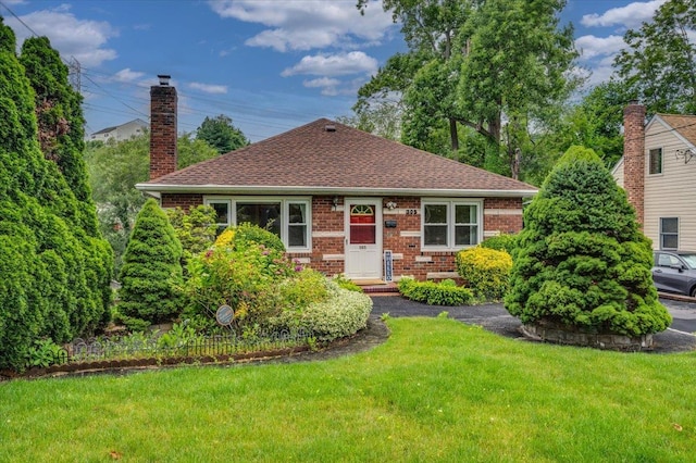 303 Helena Ave, Yonkers, NY 10710 - bungalow-style home featuring brick siding, a front yard, and roof with shingles