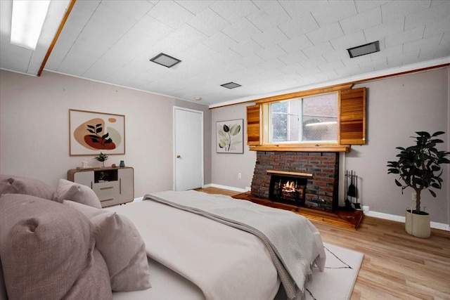303 Helena Ave, Yonkers, NY 10710 - bedroom with light wood-type flooring and a brick fireplace