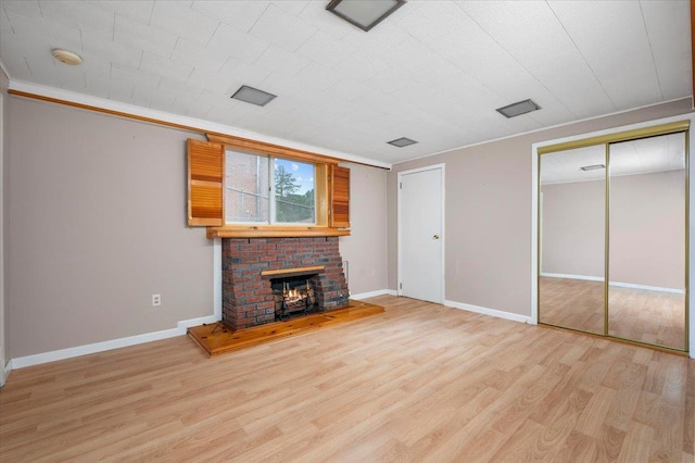 303 Helena Ave, Yonkers, NY 10710 - unfurnished living room featuring light wood finished floors and a fireplace