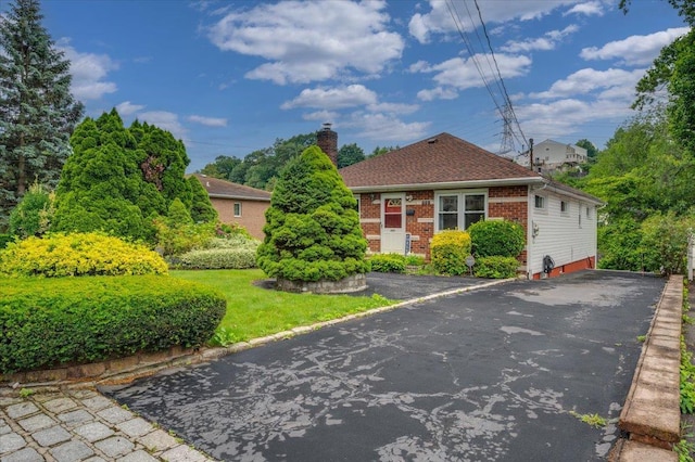 303 Helena Ave, Yonkers, NY 10710 - view of front of house featuring a chimney, brick siding, and driveway