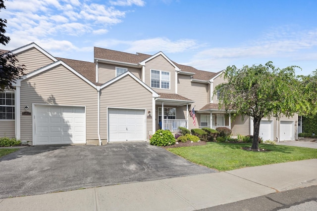 48 Sparrow Ridge Rd, Carmel, NY 10512 - view of front of home featuring driveway, a front lawn, an attached garage, and covered porch