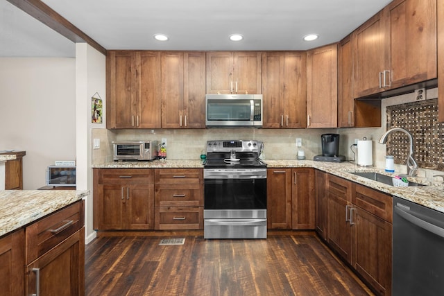 48 Sparrow Ridge Rd, Carmel, NY 10512 - kitchen featuring stainless steel appliances, dark wood-type flooring, backsplash, light stone counters, and recessed lighting