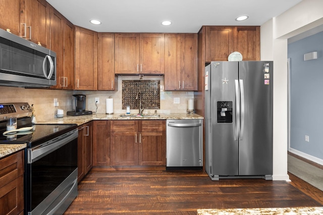 48 Sparrow Ridge Rd, Carmel, NY 10512 - kitchen with appliances with stainless steel finishes, dark wood-style flooring, backsplash, light stone counters, and recessed lighting