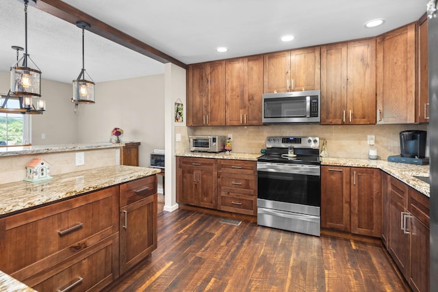 48 Sparrow Ridge Rd, Carmel, NY 10512 - kitchen featuring appliances with stainless steel finishes, dark wood-style flooring, tasteful backsplash, light stone countertops, and decorative light fixtures