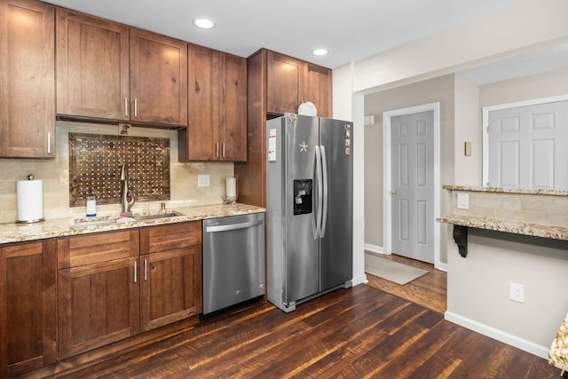 48 Sparrow Ridge Rd, Carmel, NY 10512 - kitchen with appliances with stainless steel finishes, dark wood-style flooring, decorative backsplash, light stone countertops, and recessed lighting
