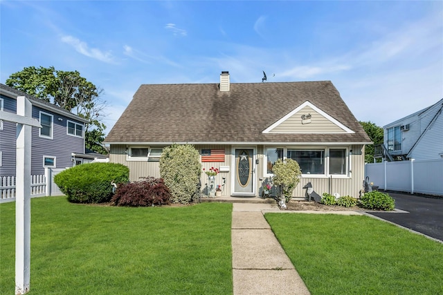 18 Seawane Rd, East Rockaway, NY 11518 - view of front of house with a chimney, roof with shingles, and board and batten siding