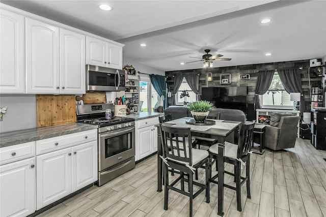 18 Seawane Rd, East Rockaway, NY 11518 - kitchen featuring appliances with stainless steel finishes, ceiling fan, recessed lighting, white cabinets, and light wood-type flooring