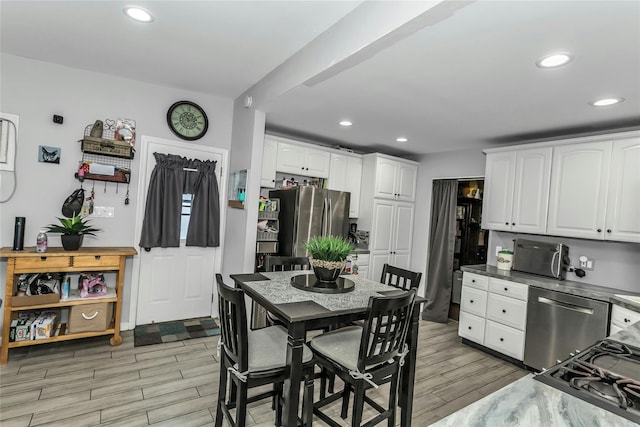 18 Seawane Rd, East Rockaway, NY 11518 - kitchen featuring stainless steel appliances, white cabinets, light wood-type flooring, and recessed lighting