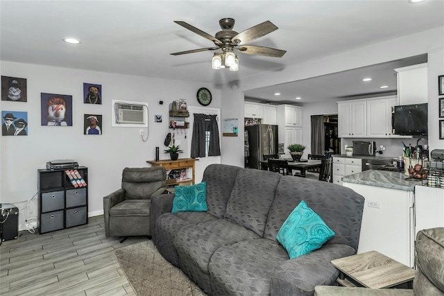 18 Seawane Rd, East Rockaway, NY 11518 - living area with a wall mounted air conditioner, ceiling fan, recessed lighting, and light wood-style flooring