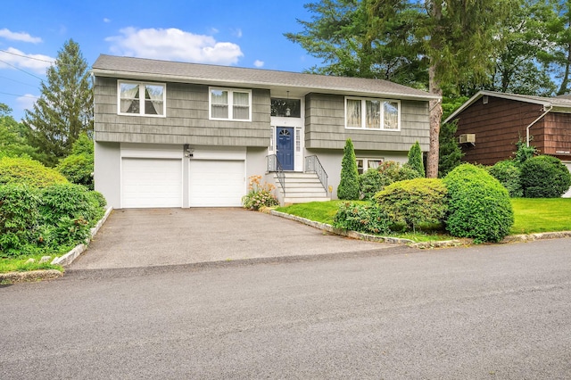 7 Frost Ln, Hartsdale, NY 10530 - raised ranch featuring driveway, a garage, and stucco siding