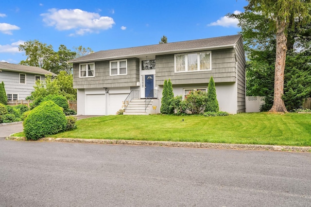 7 Frost Ln, Hartsdale, NY 10530 - bi-level home featuring an attached garage, a front yard, driveway, and stucco siding