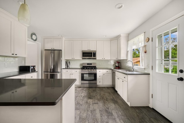 7 Frost Ln, Hartsdale, NY 10530 - kitchen featuring stainless steel appliances, dark countertops, backsplash, white cabinetry, and recessed lighting