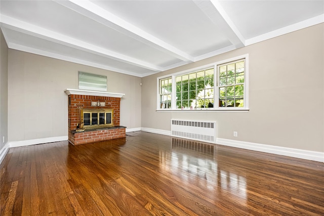 45 Mc Cue Ln, Babylon, NY 11702 - unfurnished living room featuring radiator heating unit, beamed ceiling, wood finished floors, and a brick fireplace