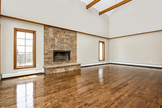 45 Mc Cue Ln, Babylon, NY 11702 - unfurnished living room featuring a baseboard heating unit, high vaulted ceiling, wood finished floors, beam ceiling, and a stone fireplace