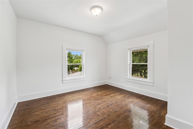 401 Ocean Ave, Malverne, NY 11565 - spare room with vaulted ceiling and dark wood-style floors