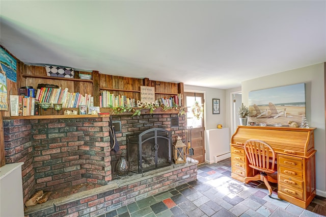 123 Lake St, Islip, NY 11751 - living area featuring a baseboard heating unit, wood walls, and a brick fireplace
