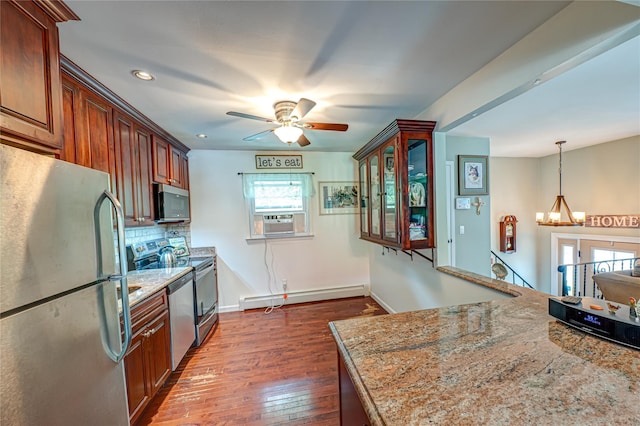 123 Lake St, Islip, NY 11751 - kitchen with appliances with stainless steel finishes, a baseboard radiator, ceiling fan, cooling unit, and dark wood-style flooring