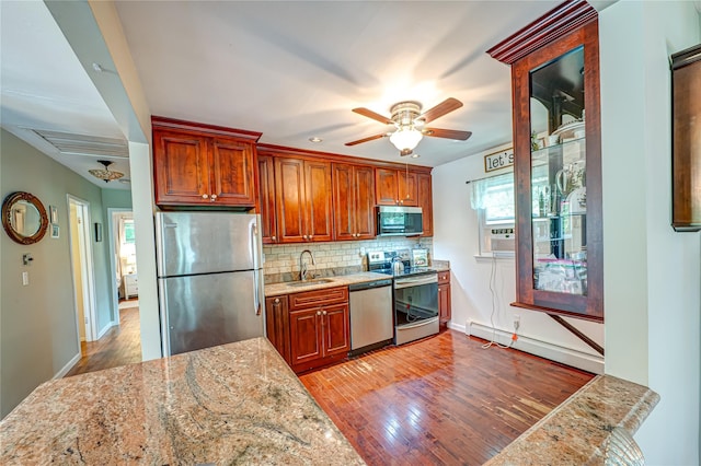 123 Lake St, Islip, NY 11751 - kitchen with stainless steel appliances, a ceiling fan, wood-type flooring, and tasteful backsplash