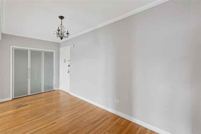 33-25 90th St Unit 3A, Jackson Heights, NY 11372 - unfurnished dining area with a chandelier, light wood finished floors, and ornamental molding