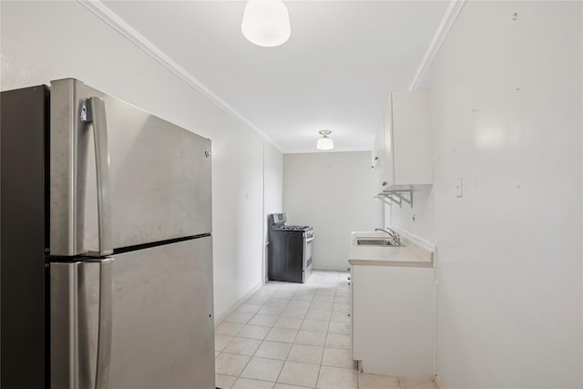 33-25 90th St Unit 3A, Jackson Heights, NY 11372 - kitchen featuring appliances with stainless steel finishes, ornamental molding, white cabinets, light countertops, and light tile patterned flooring