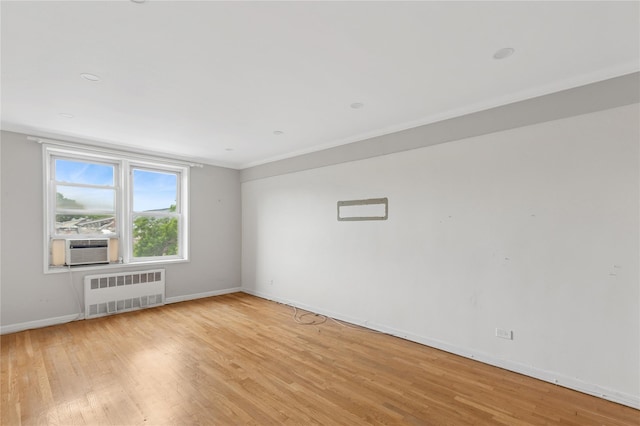 33-25 90th St Unit 3A, Jackson Heights, NY 11372 - unfurnished room featuring radiator, light wood-style flooring, cooling unit, and crown molding