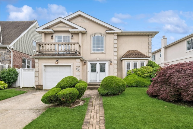230 W Beech St, Long Beach, NY 11561 - view of front of home featuring a balcony, a garage, stucco siding, and concrete driveway