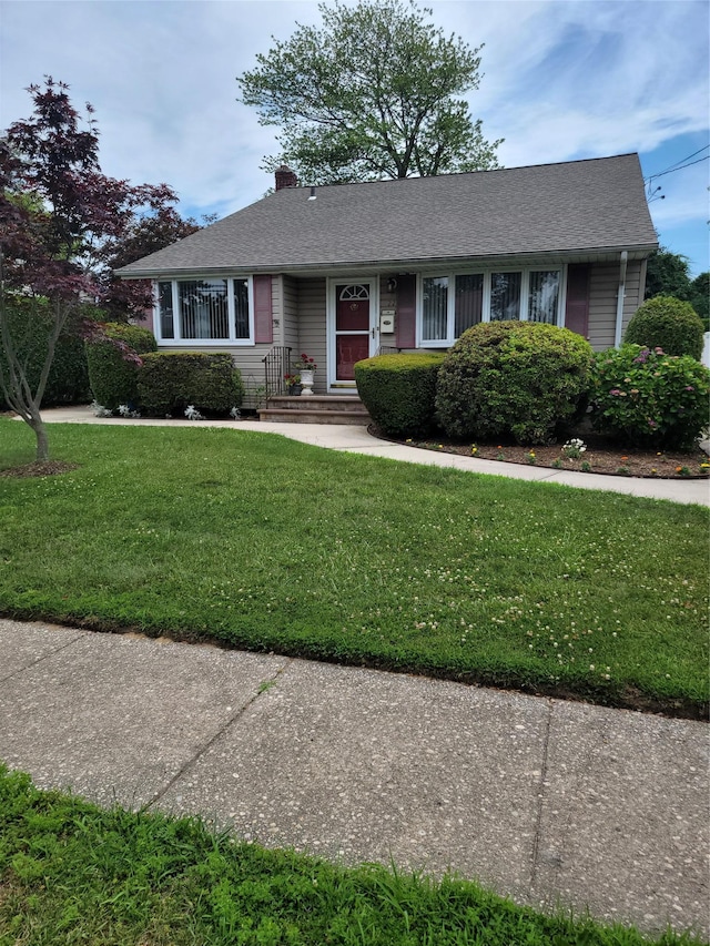 view of front of property with a front lawn and a chimney