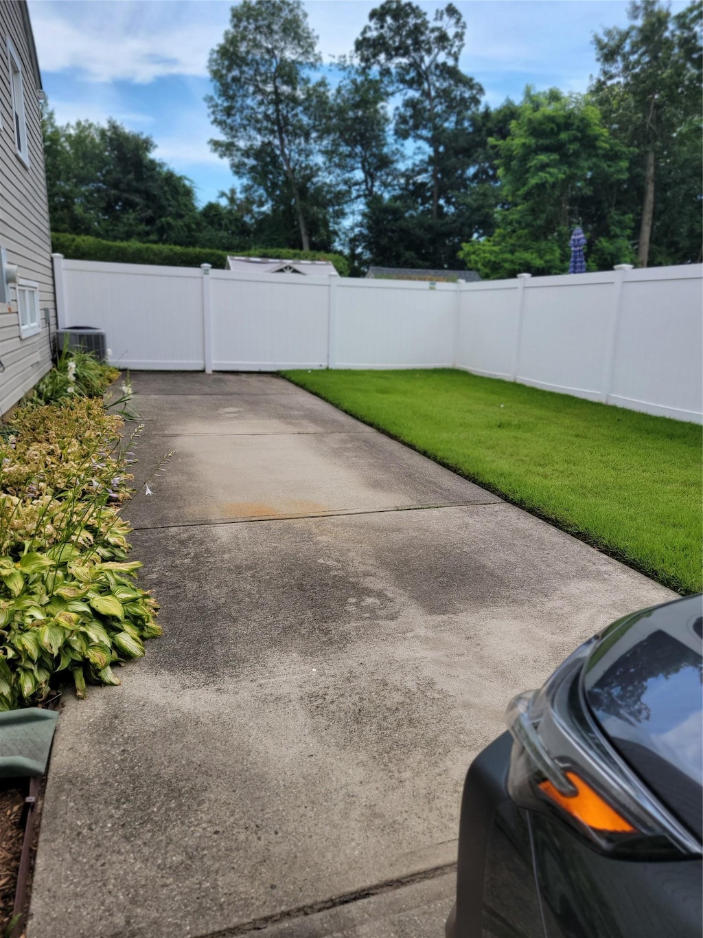 fenced backyard with a patio area