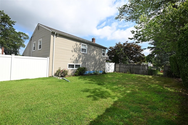 22 Victoria Rd, North Babylon, NY 11703 - view of side of home with a chimney
