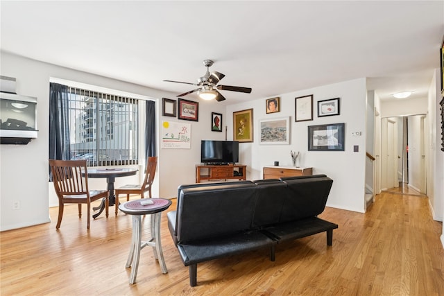 425 Shore Rd Unit 1A, Long Beach, NY 11561 - living area featuring ceiling fan, light wood-style floors, and stairway