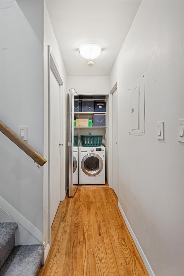 425 Shore Rd Unit 1A, Long Beach, NY 11561 - washroom with washing machine and dryer, electric panel, and light wood-type flooring