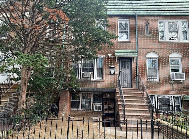 687 E 42nd St, Brooklyn, NY 11203 - view of front of home with brick siding, a fenced front yard, and cooling unit