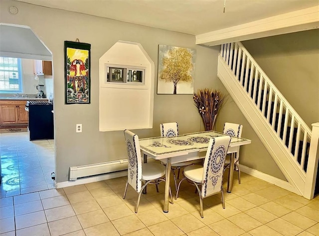 687 E 42nd St, Brooklyn, NY 11203 - dining area featuring a baseboard heating unit, light tile patterned flooring, and stairs