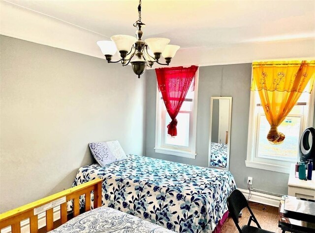 687 E 42nd St, Brooklyn, NY 11203 - bedroom with a chandelier and wood finished floors