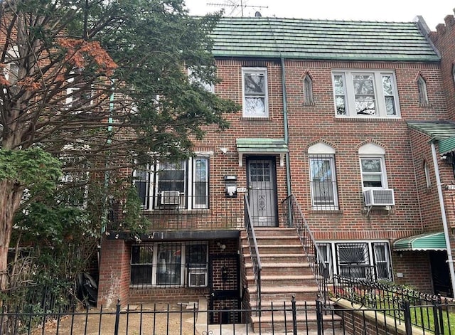 687 E 42nd St, Brooklyn, NY 11203 - view of front of home with brick siding, a fenced front yard, and cooling unit