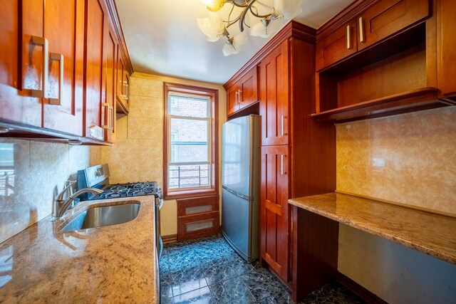 62-59 108th St Unit 4N, Forest Hills, NY 11375 - kitchen featuring freestanding refrigerator, gas stove, a chandelier, decorative backsplash, and light stone counters