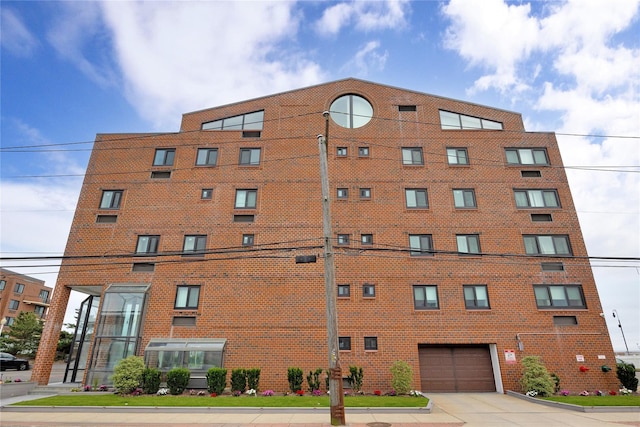 750 Broadway W Unit 3M, Long Beach, NY 11561 - view of building exterior with an attached garage and driveway