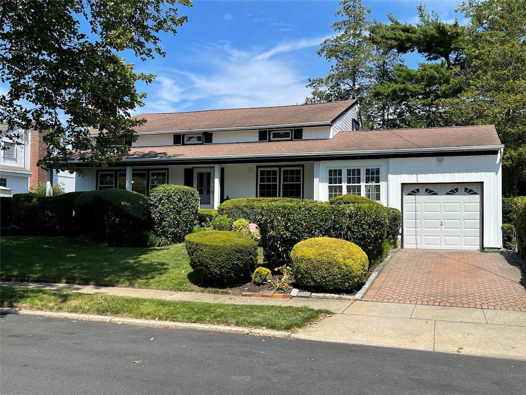 55 Laurel Dr, Massapequa Park, NY 11762 - traditional home with a garage and decorative driveway