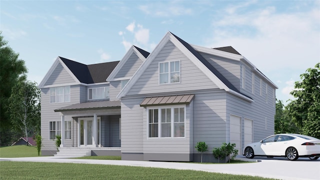 34 Old Main Rd, Quogue, NY 11959 - view of front of home featuring a standing seam roof, a metal roof, and an attached garage
