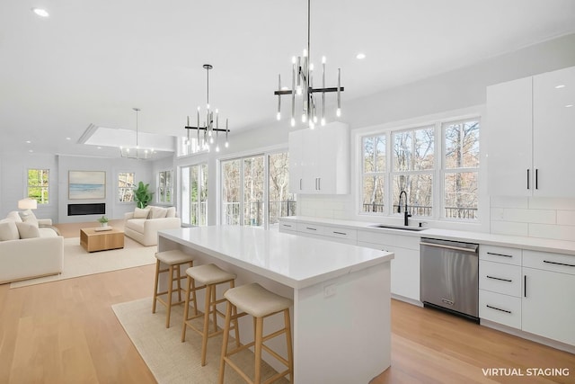 34 Old Main Rd, Quogue, NY 11959 - kitchen featuring stainless steel dishwasher, modern cabinets, a chandelier, recessed lighting, and light wood-type flooring