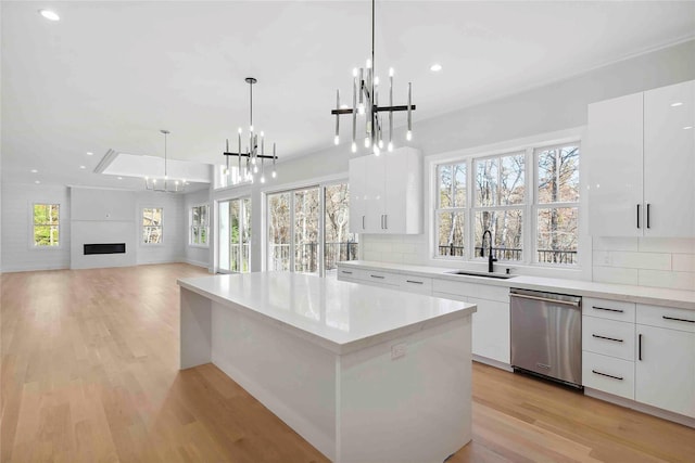 34 Old Main Rd, Quogue, NY 11959 - kitchen featuring dishwasher, a chandelier, modern cabinets, light wood finished floors, and recessed lighting