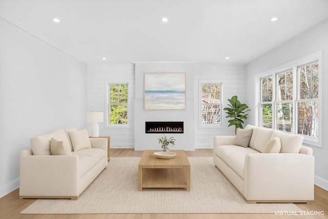 34 Old Main Rd, Quogue, NY 11959 - living area with healthy amount of natural light, recessed lighting, wood finished floors, and a lit fireplace
